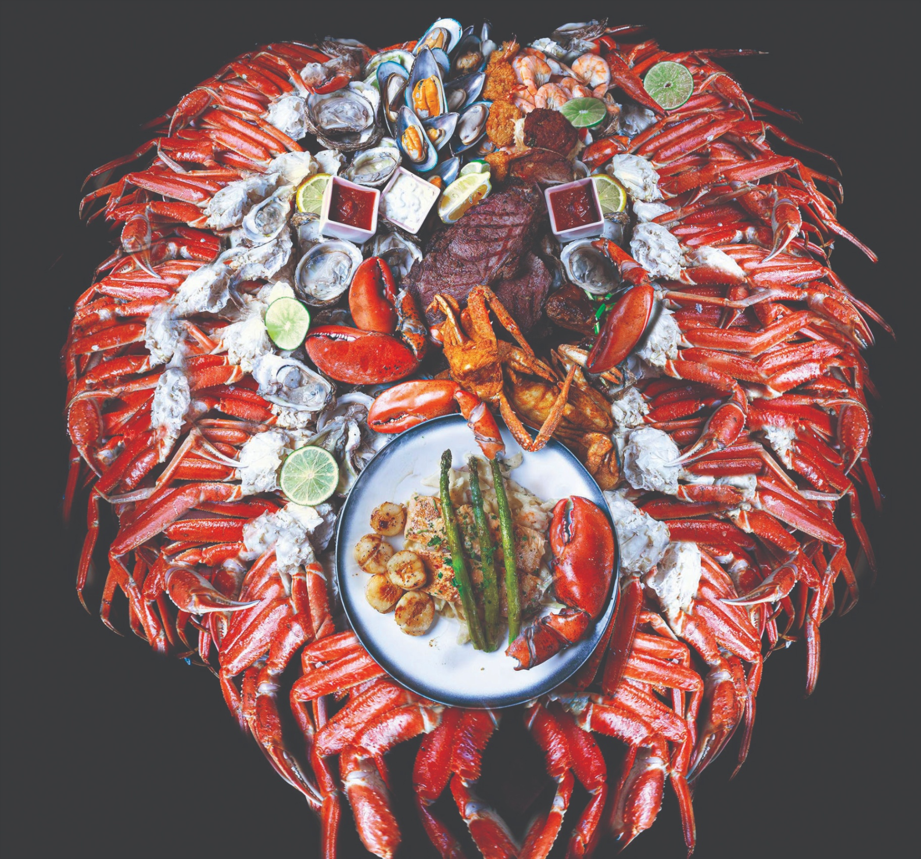 HOOKS signature seafood tower — mountain of snow crab, oysters, mussels, lobster and prime rib